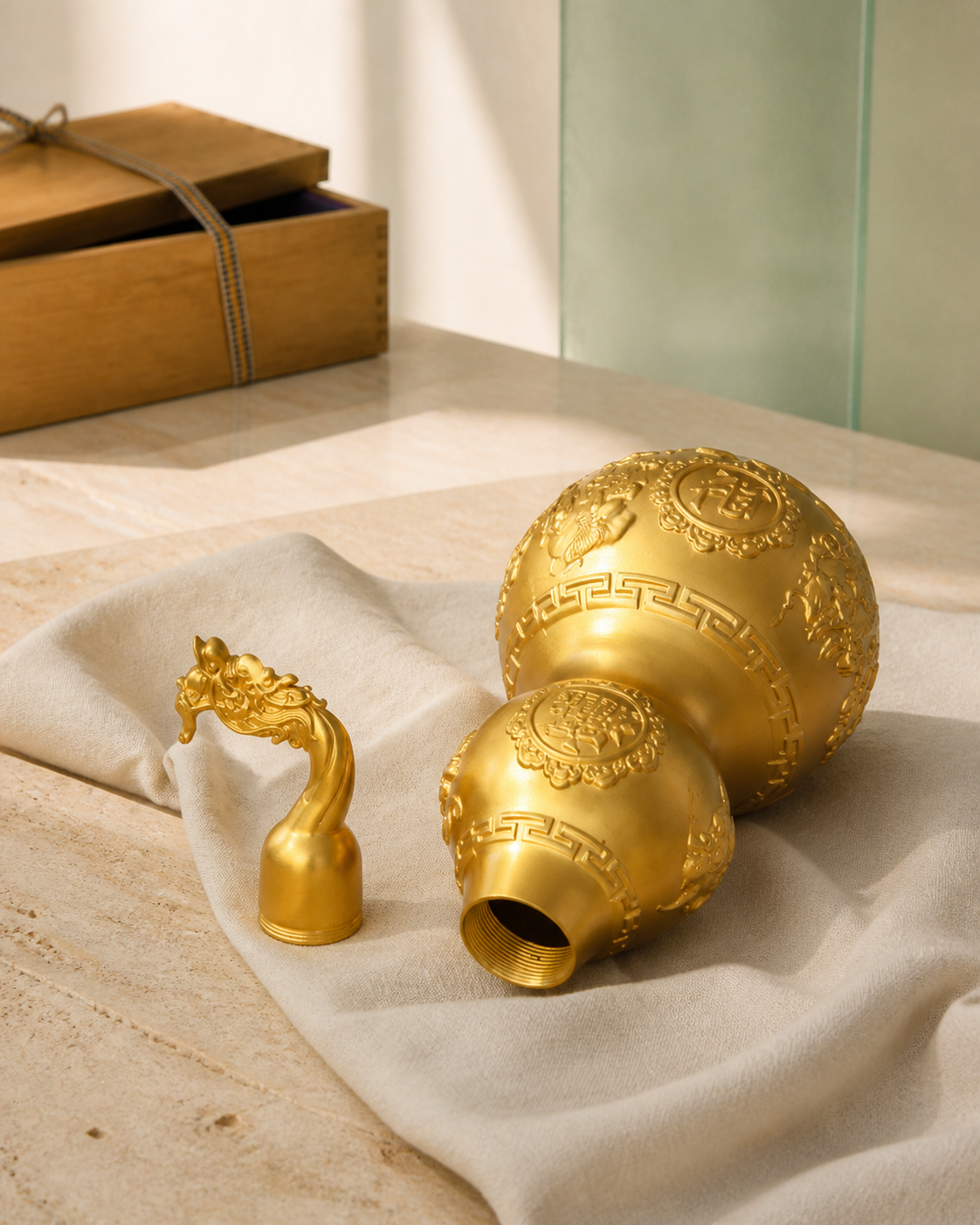 WULU Celestial Guardian brass vessel lying open on ivory fabric with its dragon-head lid removed.