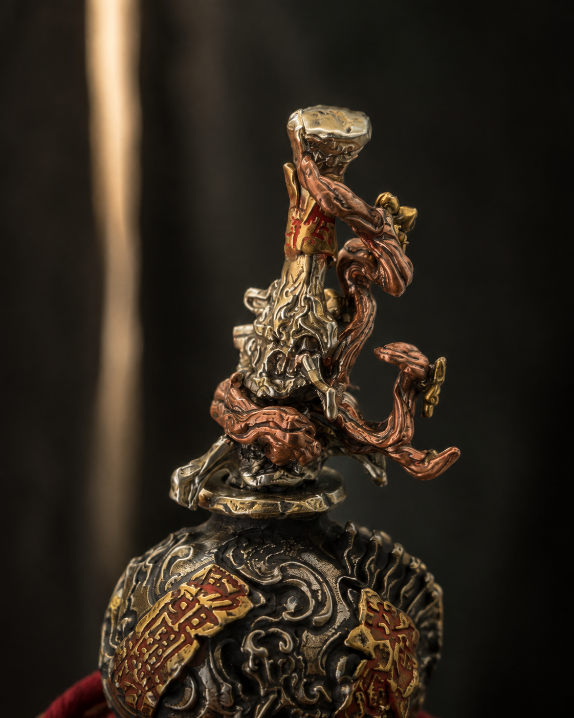 Close-up of the sculptural sword hilt at the top of the XUAN MO gourd.